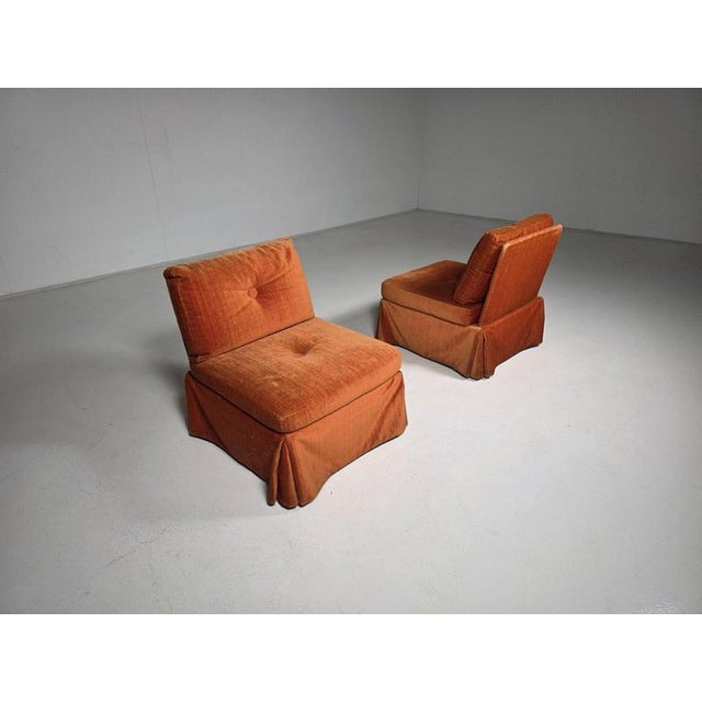 Pair of sculptural burned orange Italian lounge chairs, circa 1970s Newly re-webbed and retaining what appears to be their...
