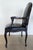 Pair of carved walnut frame arm chairs with black leather and brass nail head trim. Some age wear to leather and wood. The...