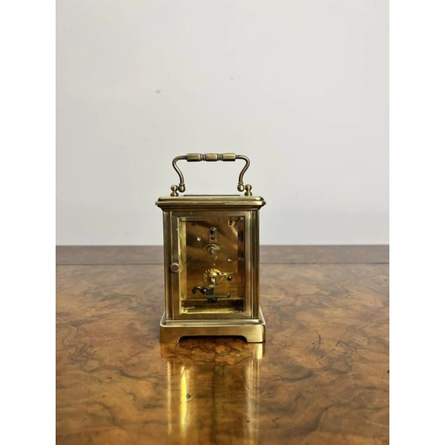 Quality antique Victorian brass carriage clock having a quality brass case with bevelled glass, white enamel dial with the...