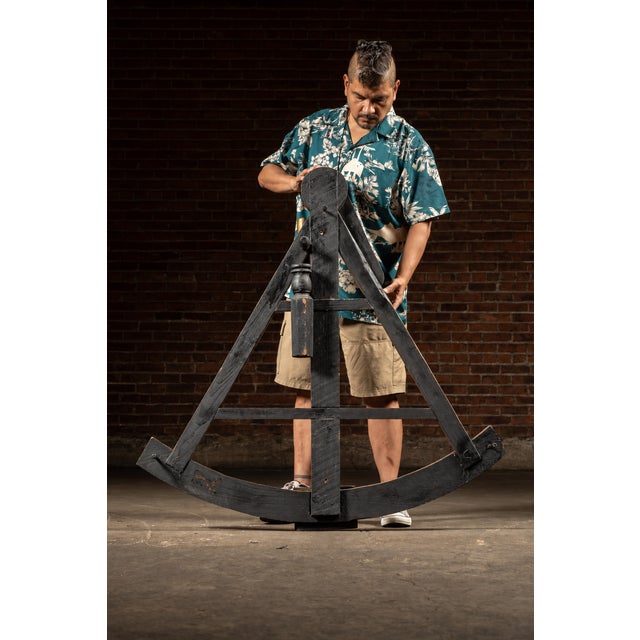 Large-scale wooden figural octant with painted degree scale. Standing nearly four feet tall, this oversize representation...