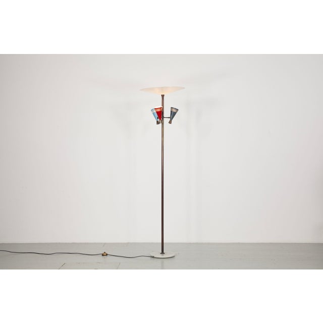 Italian floor lamp from the 1950s. The lamp has painted aluminum shades in red, light blue, and dark blue, a brass frame,...