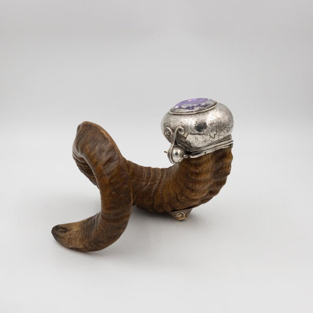 Natural ram’s horn with characteristic spiral form. Hallmarked silver mount engraved with traditional thistle motifs,...
