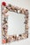 Beautiful vintage hand-crafted wall mirror encased in varied sea shells. Wood frame painted in a metallic silver. Beveled...