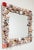 Beautiful vintage hand-crafted wall mirror encased in varied sea shells. Wood frame painted in a metallic silver. Beveled...