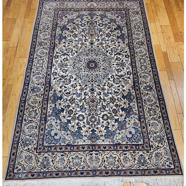 "This vintage Persian Nain rug offers a rare and unusually warm interpretation of the classic Nain design vocabulary —...