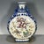 A striking Chinese porcelain moon flask (baoyueping). The vase features a flat, circular body with a short neck and...