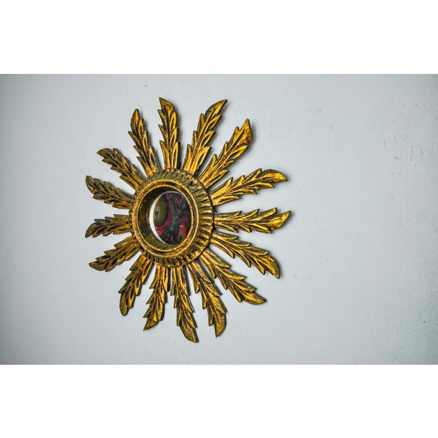 Very beautiful wooden sun mirror gilded with gold leaf dating from 1960. Superb wood work. Good state of conservation with...
