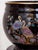 An elegant set consisting of a porcelain flower pot and a tall column base. The entire set is finished in black glaze with...