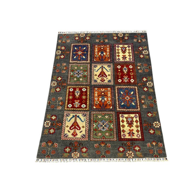 This Bakhtiari Persian style rug features a Kheshti garden panel design: twelve framed panels with stylized tree of life...