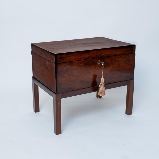 An early 19th-century mahogany cellarette or document chest, dating to circa 1830, raised on a later custom stand. The...