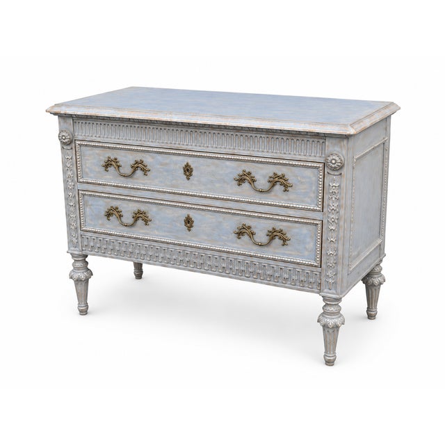 Carved Wood Chests Featuring Two Drawers With Decorative Brass Handles, Fluted Details, And Carved Floral Elements On Legs...