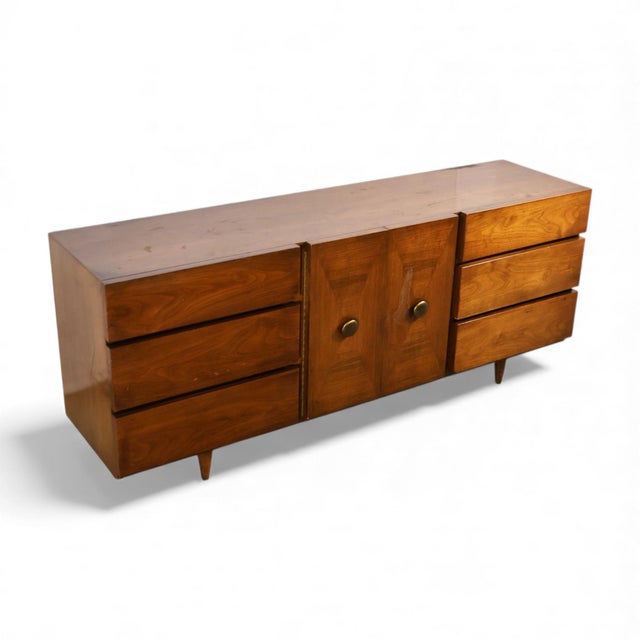 The 1960s American of Martinsville lowboy dresser captures the refined simplicity and sculptural appeal of mid-century...