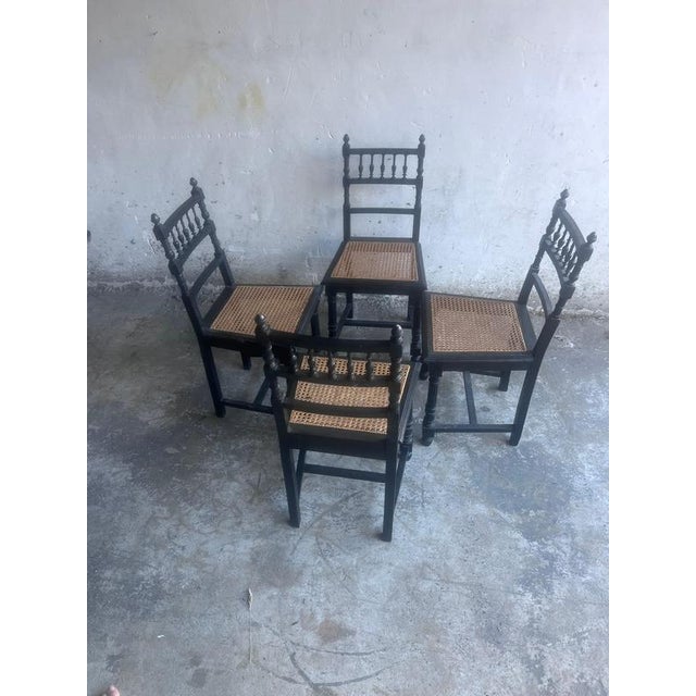 This elegant set of four dining chairs dates to the early 20th century and is crafted from solid wood with a rich ebonized...