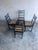 This elegant set of four dining chairs dates to the early 20th century and is crafted from solid wood with a rich ebonized...