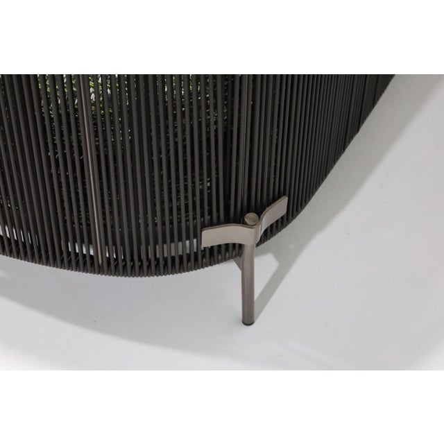 Minotti outdoor Tape sofa in excellent condition. Upholstery is Butterfly color Oliva. Straping is Licorice.