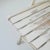 A set of wooden folding outdoor chairs created in 20th century France. Collapsible lawn chairs clad in a pleasing off-...