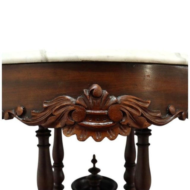 This exquisite antique Renaissance Revival table features a turtle-top white marble surface elegantly poised upon a richly...