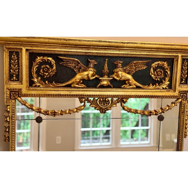 This exquisite mirror carries with it the elegance and craftsmanship of a bygone era. It features an ornately carved wood...