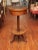 A charming 19th century table, the top, with a drawer, in the form of a drum and covered in black leather-like canvas. The...