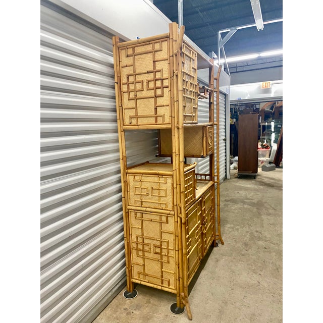 Etagere features an asymmetric, multilevel shelf configuration alongside multiple built-in woven cabinets, combining...