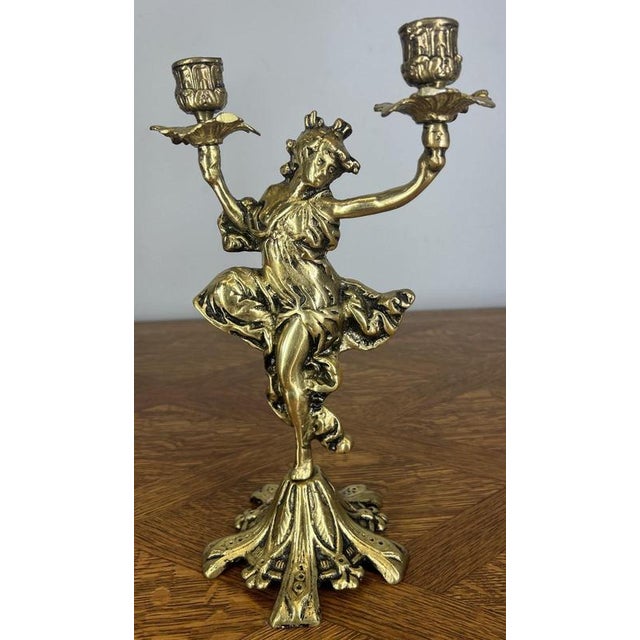 A striking Vintage French pair of candelabras , beautifully cast with elegant figural forms holding candle cups aloft,...