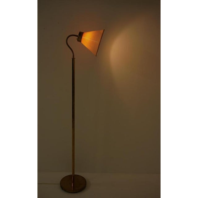 Swedish floor lamp model "1838," designed by josef frank for svenskt tenn in 1938. The lamp features a heavy base with a...