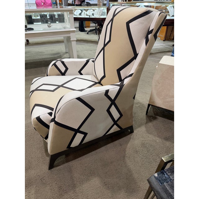 This eye-catching contemporary armchair makes a confident statement with its bold black zig zag pattern set against a...