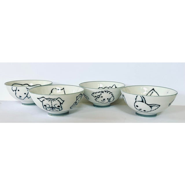 In classic blue and white, this set of 4 bowls each with a different breed of dog inside and out. Includes; pug, poodle,...