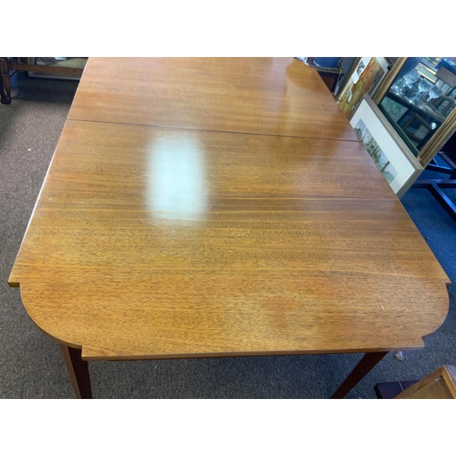 20th century Hepplewhite Mahogany table with satinwood line inlay. Cut out detail design to edges of table top. Hand...