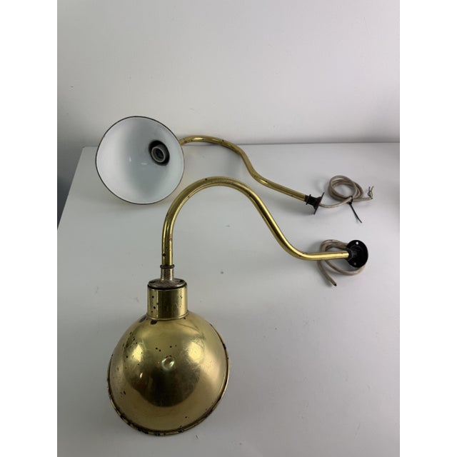 Set of 2 large industrial wall lamps with adjustable brass parabola arms, 1950s Working, in fair condition as shown in the...