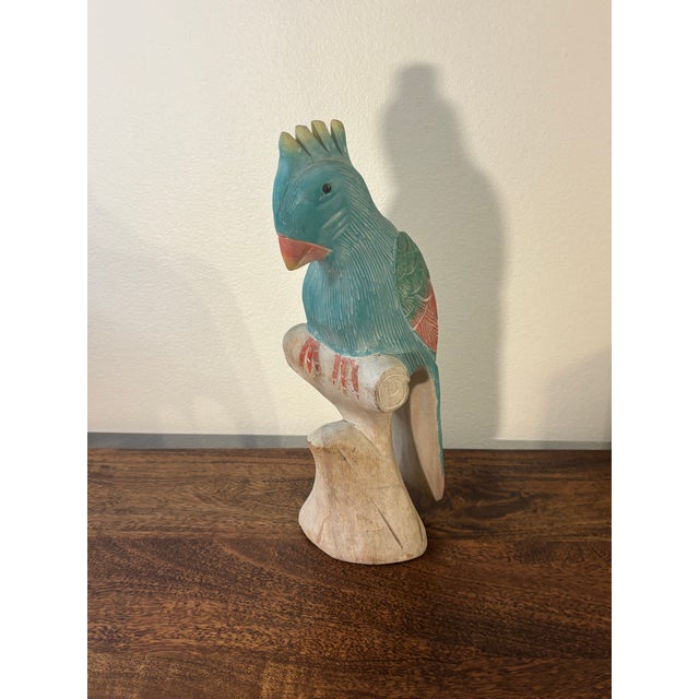 Beautiful and vibrant hand carved wooden parrot sculpture. Hand painted in bright tropical colors. Would look great in any...