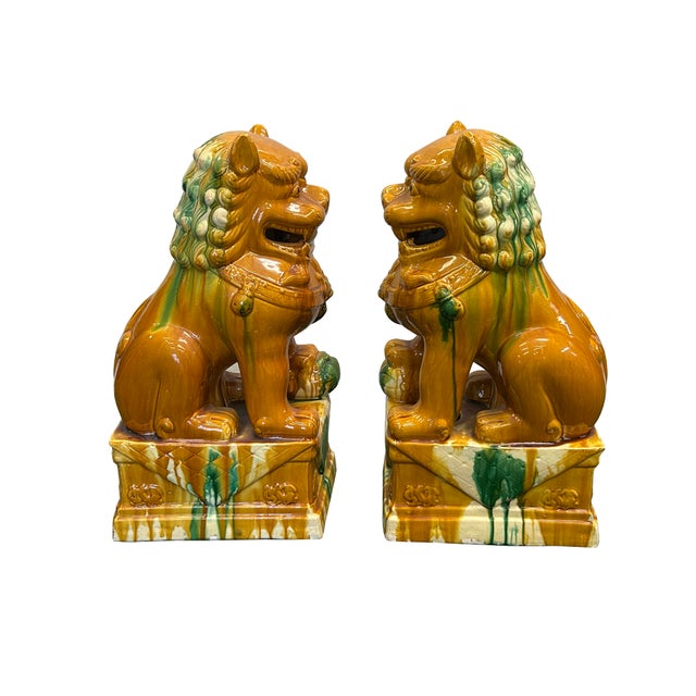 This striking pair of ceramic Foo Dogs, or Imperial Guardian Lions, is rendered in a vibrant Sancai-style palette,...