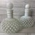 This stunning set of vintage Fenton hobnail bottles showcases the timeless elegance of white milk glass. With their...