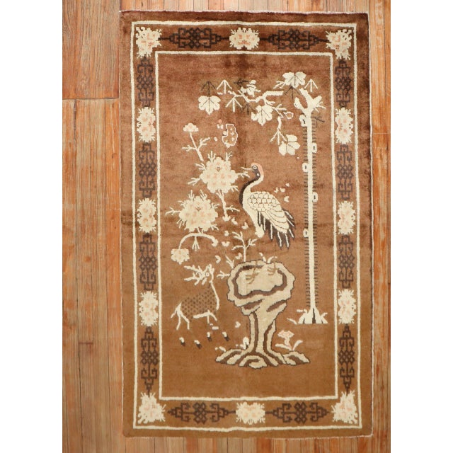 A 2nd quarter of the 20th-century Chinese Peking rug with a pictorial design in brown Size: 3'3'' x 5'2''.