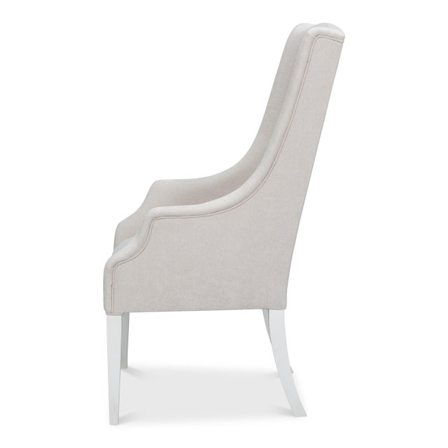 A 49-inch back frames the head of the table, giving the seat a taller and more substantial presence than the side chairs...
