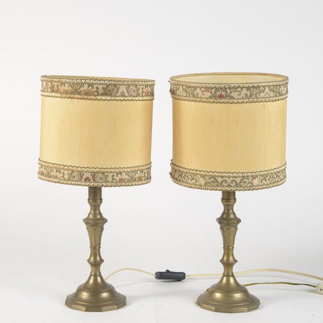 Pair of turned brass lamps, electrified lamps complete with 20th century fabric hood, measures 20.5 x h 42 category of...