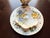 Made in Longton, Staffordshire, England, this stunning two-piece set showcases a vibrant, romantic pansy motif featuring...