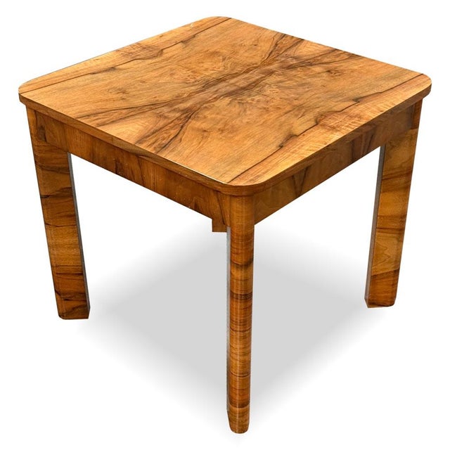 A small Art Deco coffee table featuring a striking walnut veneer with beautifully mirrored grain on the tabletop. The...