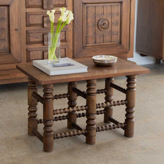 Incredible French dark oak wood side table in the style of Charles Dudouyt, 1940's. Rectangular top with intricately...