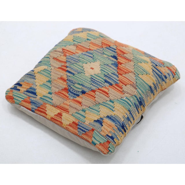 A one-of-a-kind handwoven Afghan wool kilim accent pillow featuring stacked diamonds in teal, red and gold. Cut and sewn...