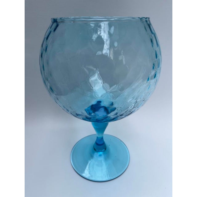 A single blue swirled blown glass footed vase or bowl.
