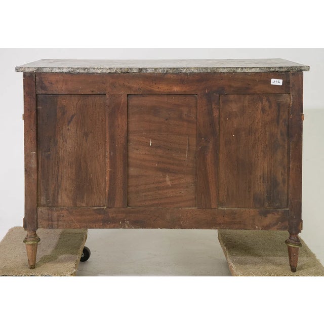 This walnut commode showcases a beautiful orginal Saint Anne marble top. It features three drawers constructed with...
