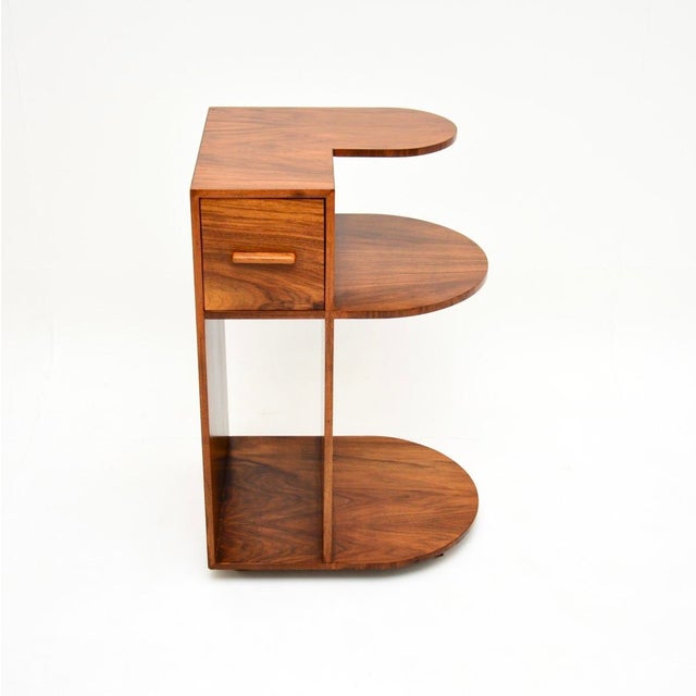 A stunning and quite unusual Art Deco figured walnut side table. This was made in England, it dates from the 1930’s. It...