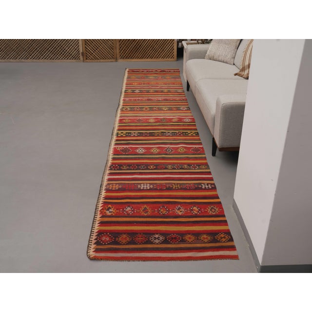 Vintage Hand-Knotted runner rug is a semi-antique vintage area rug. The '70s Eastern region of Anatolia's unique rug is...