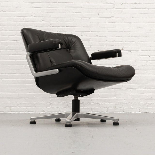 Swivel lounge chair designed by Karl Dittert for Stoll Giroflex in the 1970s. The chair features a black lacquered wooden...