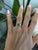 A 1.87-carat tsavorite garnet blazes in vivid, grass-green at the center of this solid 18K yellow gold ring, flanked by...