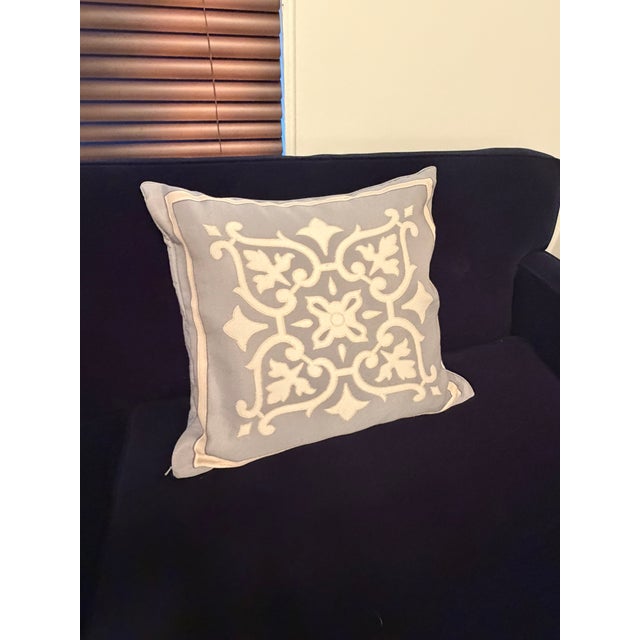 This elegant Restoration Hardware decorative pillow features a soft gray linen base with intricate white embroidered...