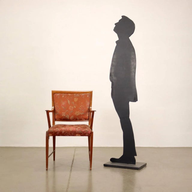 Armchair with mahogany wood structure, seat and back back. This piece is attributed to the mentioned designer/maker. It...