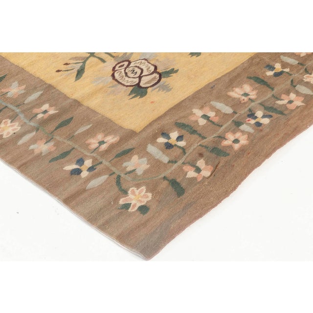 This striking antique Bessarabian rug, woven circa 1920, captures the rustic elegance and folkloric charm characteristic...