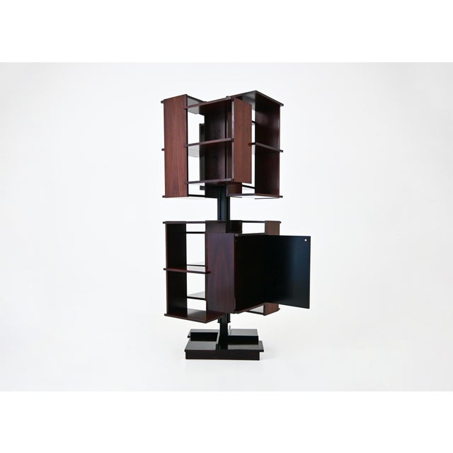 Wooden and metal bookcase designed by Claudio Salocchi in the 1960s. Model: Centro. It rotates on its own axis. Wear and...